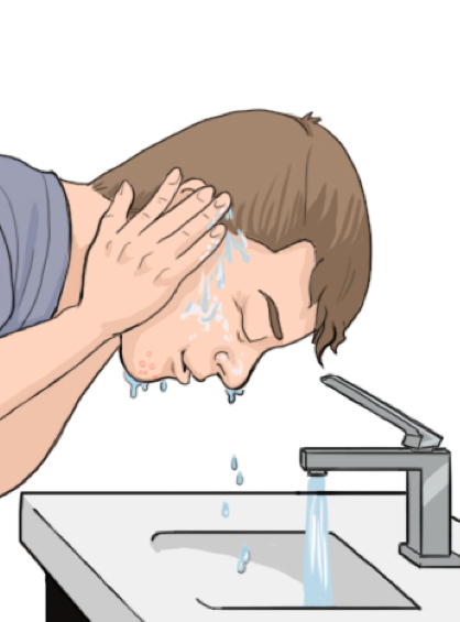 Boy at sink washing facing with water